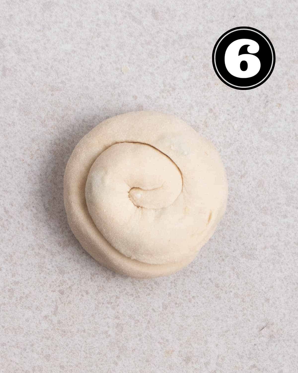 A rolled up scallion pancake dough.