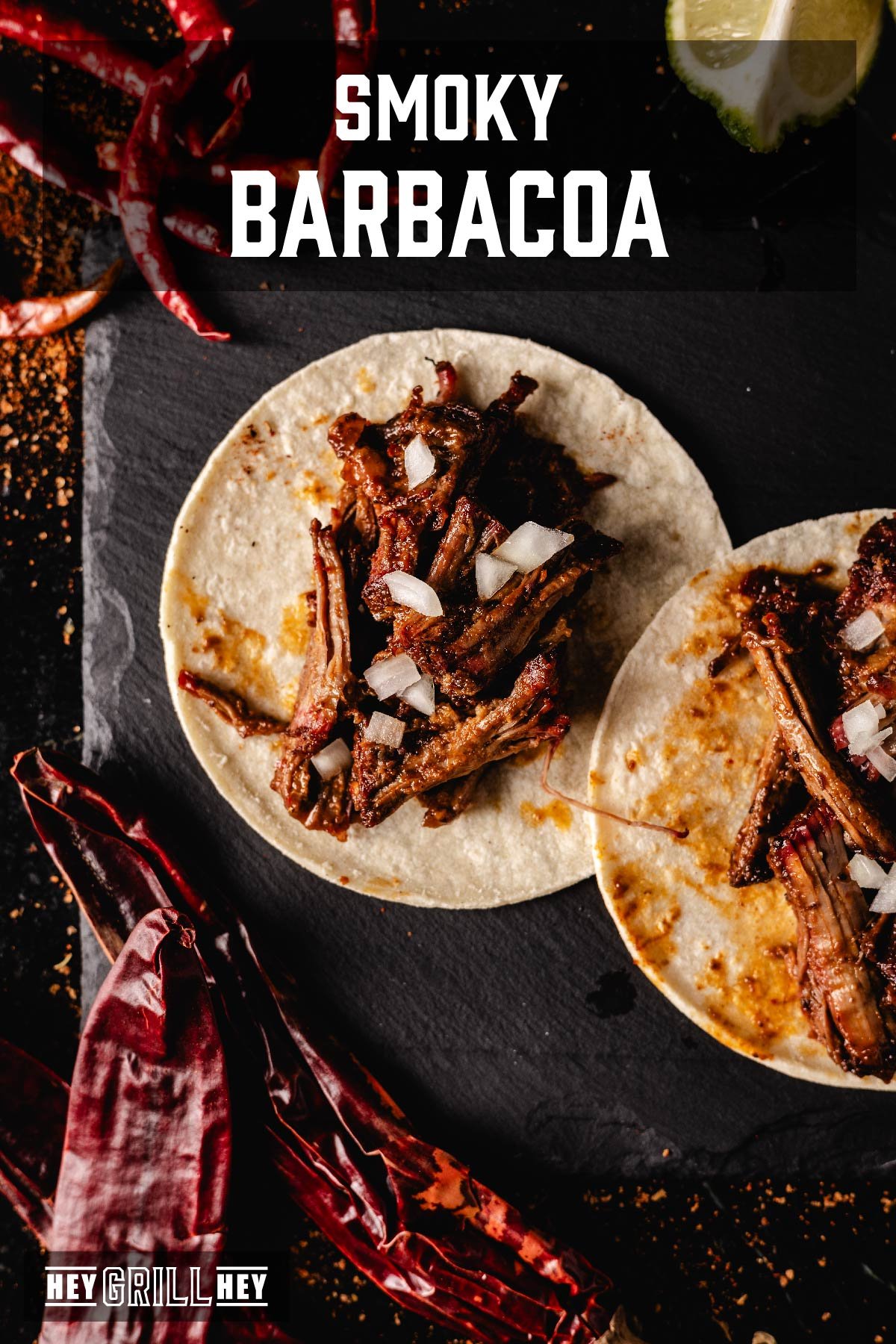 Barbacoa tacos on black serving platter. Text reads "Smoky Barbacoa".