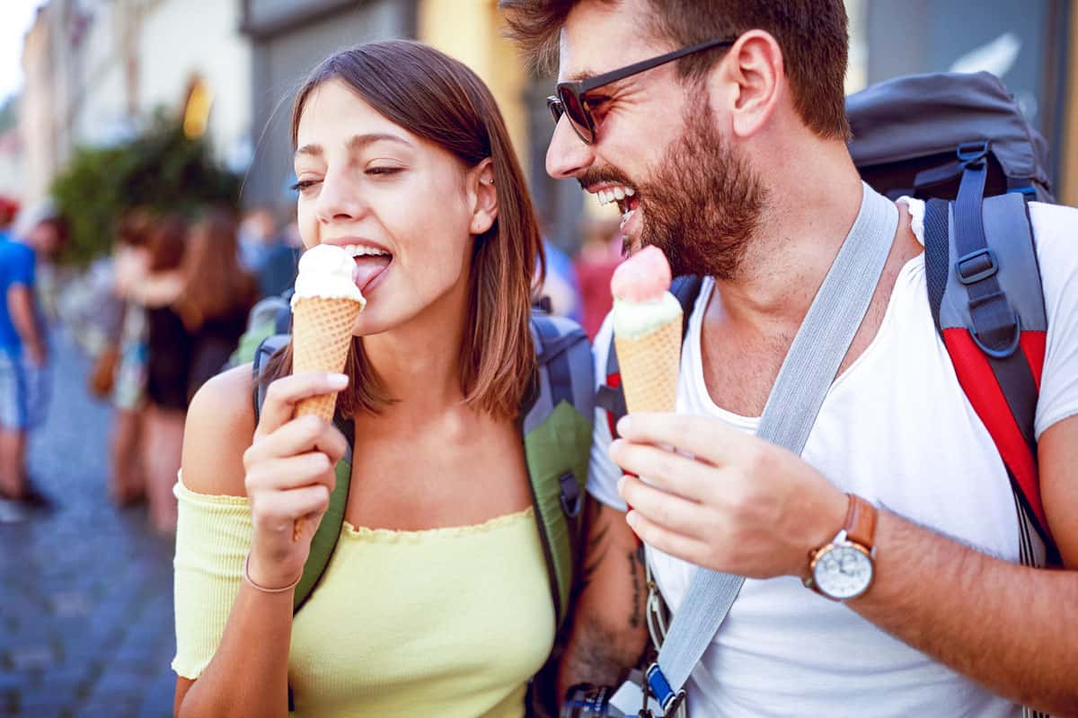 Young tourist couple enjoying gelato on a food tour in Rome in summer. Rome food tour